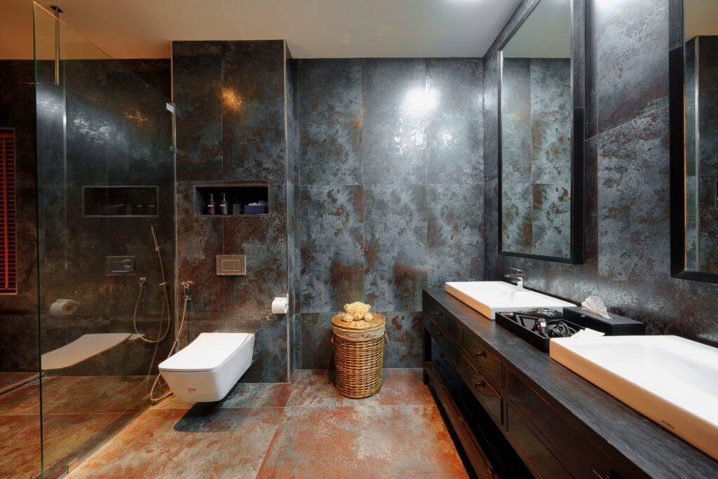 Elegantly designed deluxe king room bathroom featuring modern amenities, a spacious shower, and a luxurious freestanding tub, creating a serene and stylish retreat for guests."
