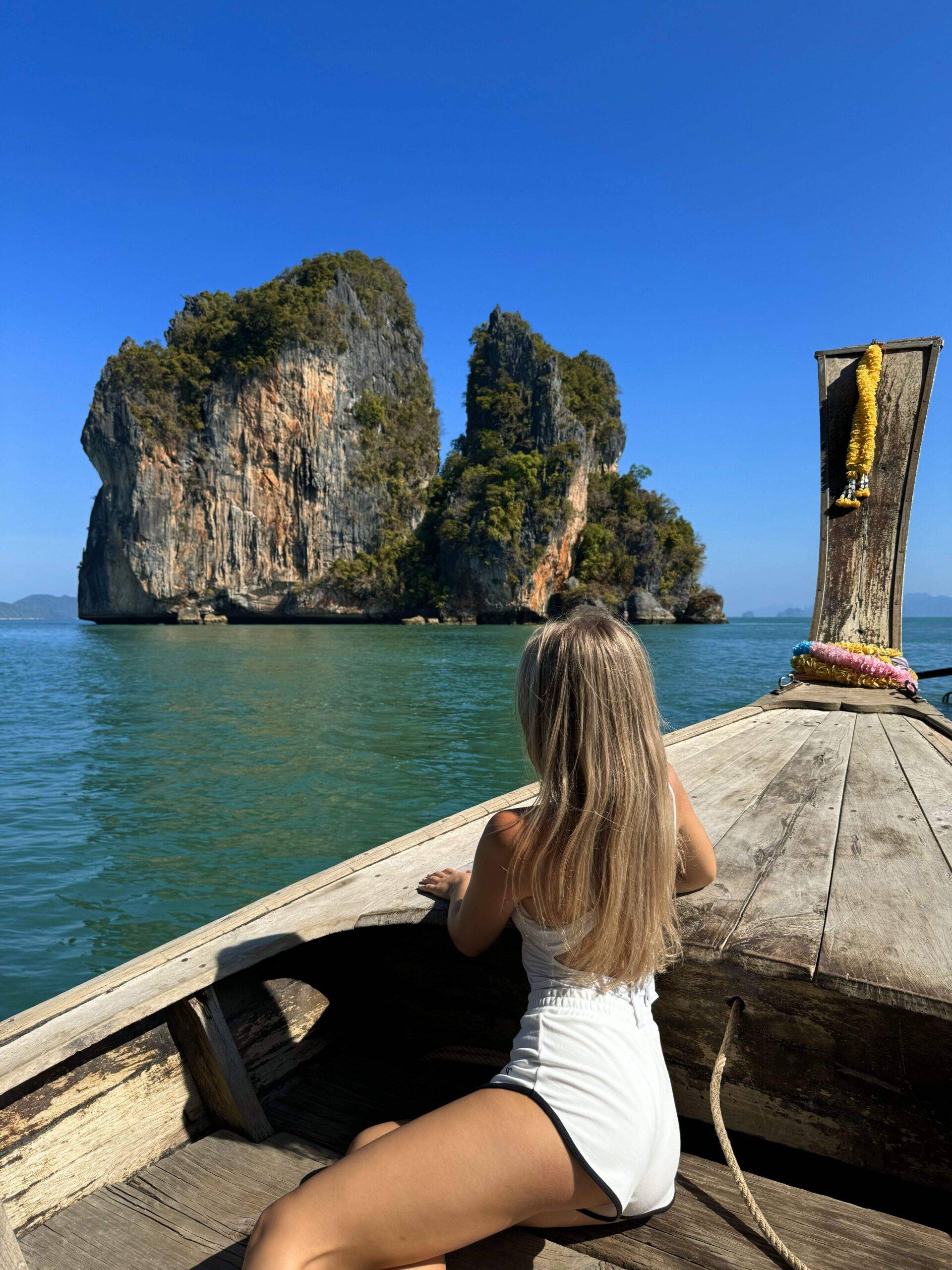 Woman on a traditional longtail boat sailing around Koh Hong in Than Bok Khorani National Park, Phang Nga Bay, Thailand"