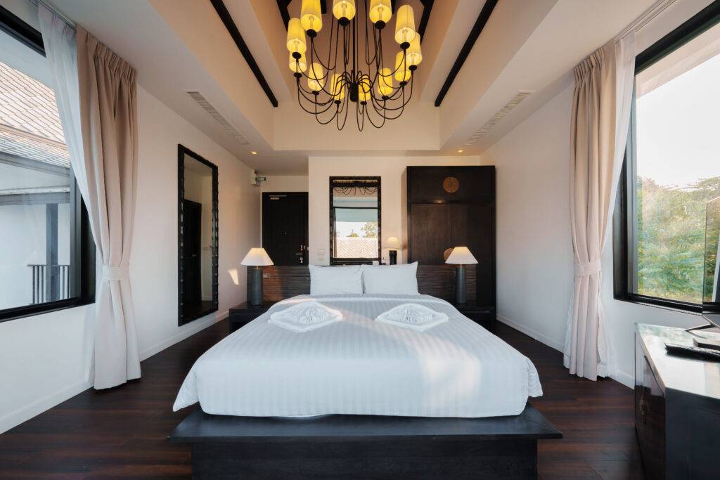 Deluxe King Room at Yao Bada Badoo, Koh Yao Yai, with king bed, chandelier and garden-view windows