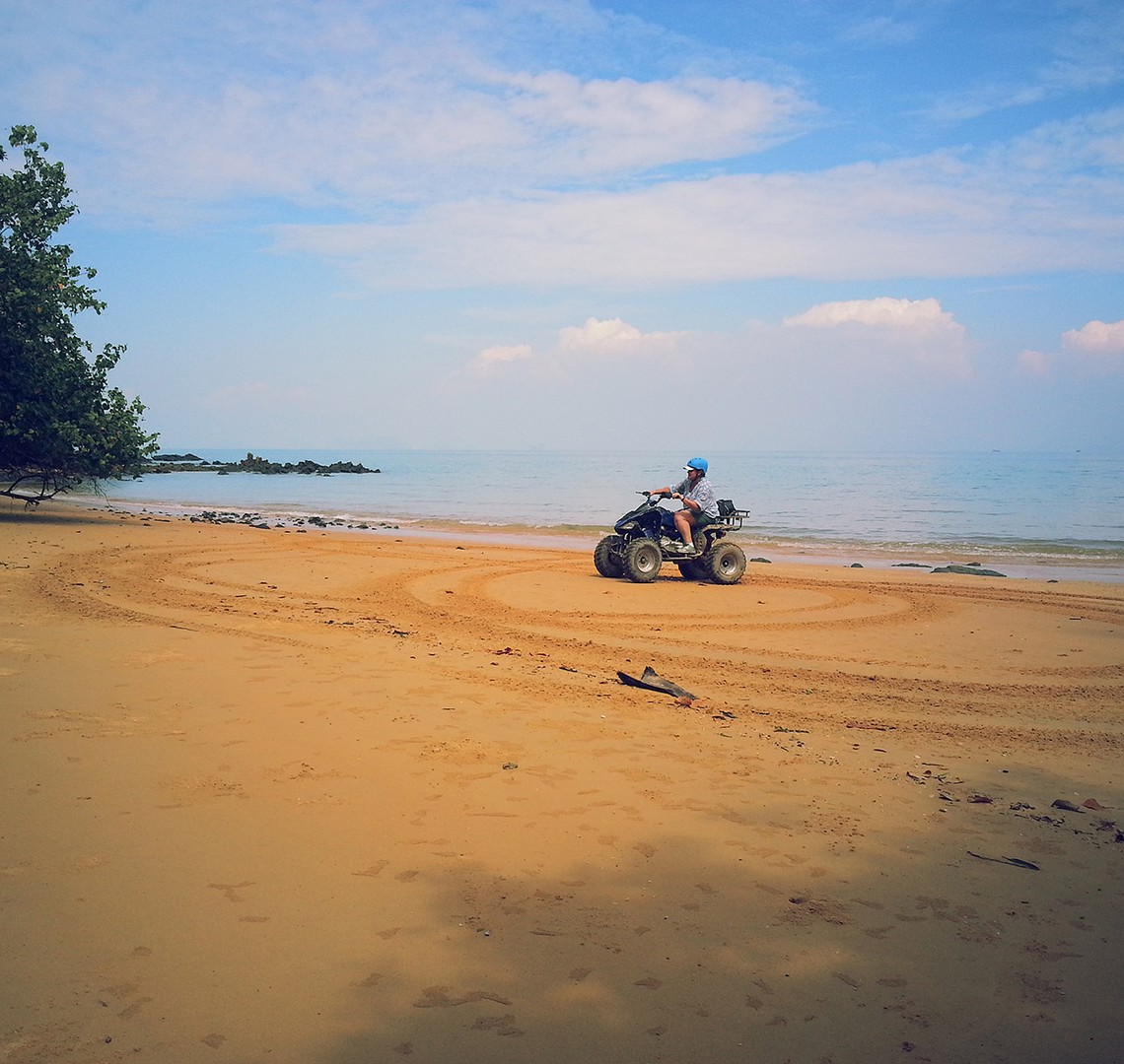 exploring a sandy tropical beach beside the sea in Koh Yao Yai