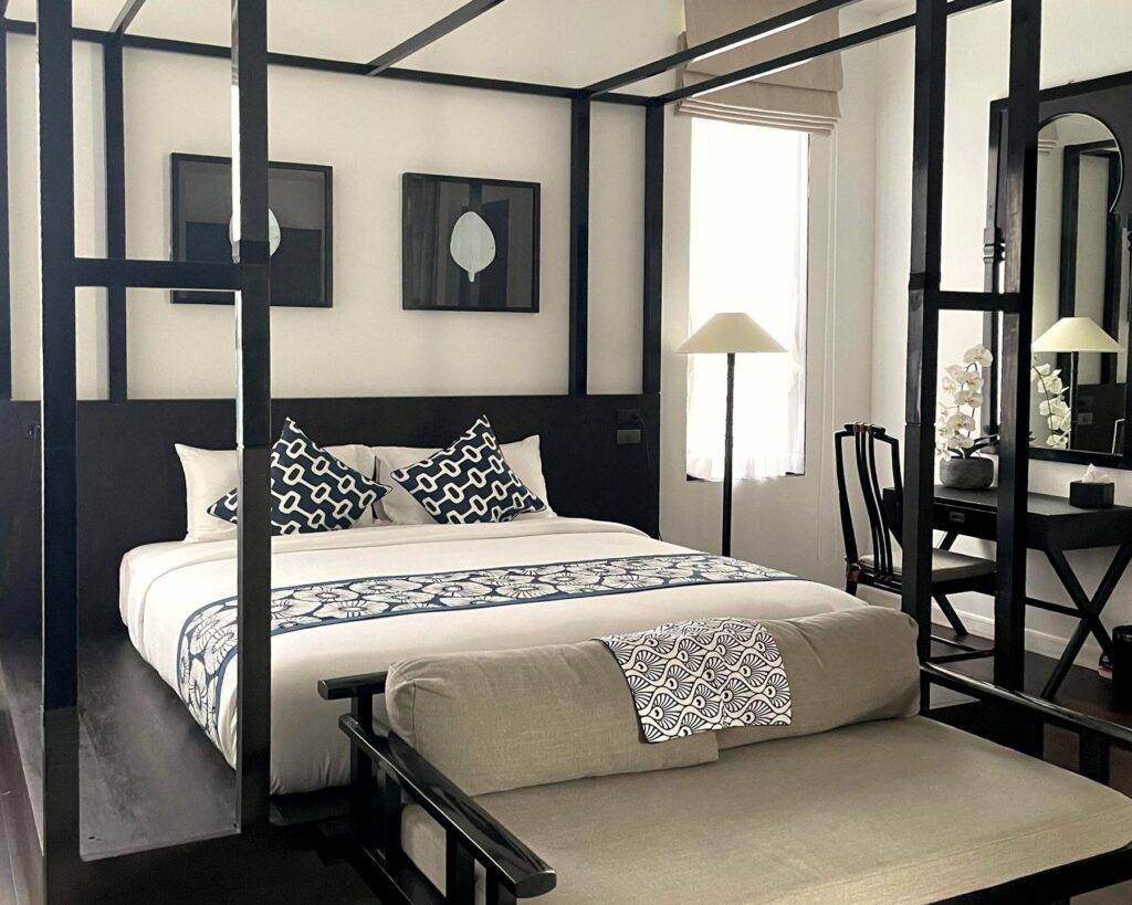 Grand Deluxe Suite with four-poster king bed, daybed and original artwork at Yao Bada Badoo, Koh Yao Yai
